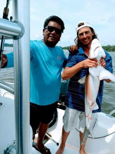 Bobby Bland standing next to a boat